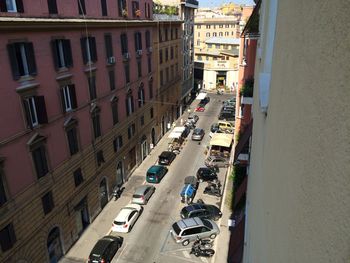 High angle view of vehicles on city street amidst buildings