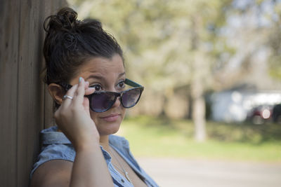 Close-up portrait of young woman in sunglasses