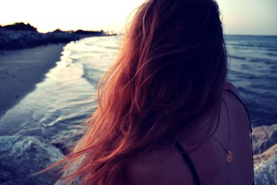 Rear view of woman standing on beach