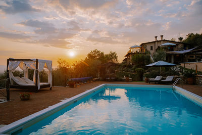 View of swimming pool at sunset