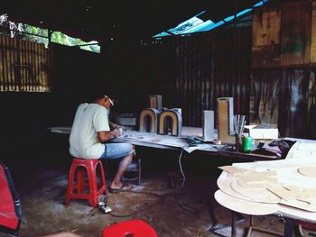 Rear view of man working at workshop