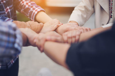 Cropped image of people forming hand chain