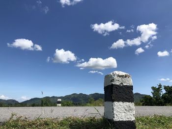 Stone wall on field against sky