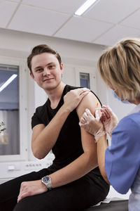 Portrait of young man getting vaccinated against covid-19