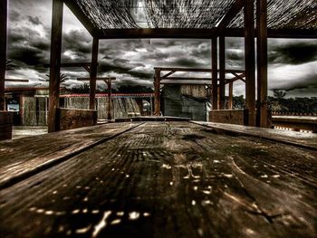 Surface level of walkway against cloudy sky