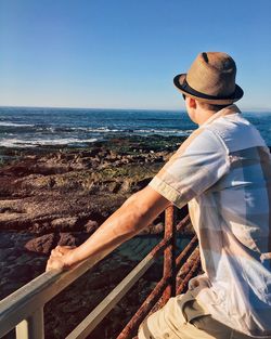 Man standing by sea against clear sky