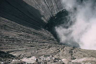 High angle view of smoke emitting through volcanic landscape at mt bromo