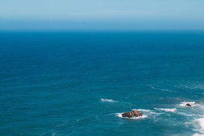 Scenic view of blue sea against sky