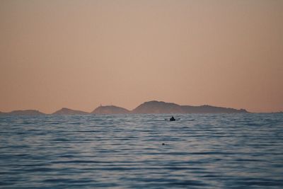 Scenic view of sea against clear sky during sunset