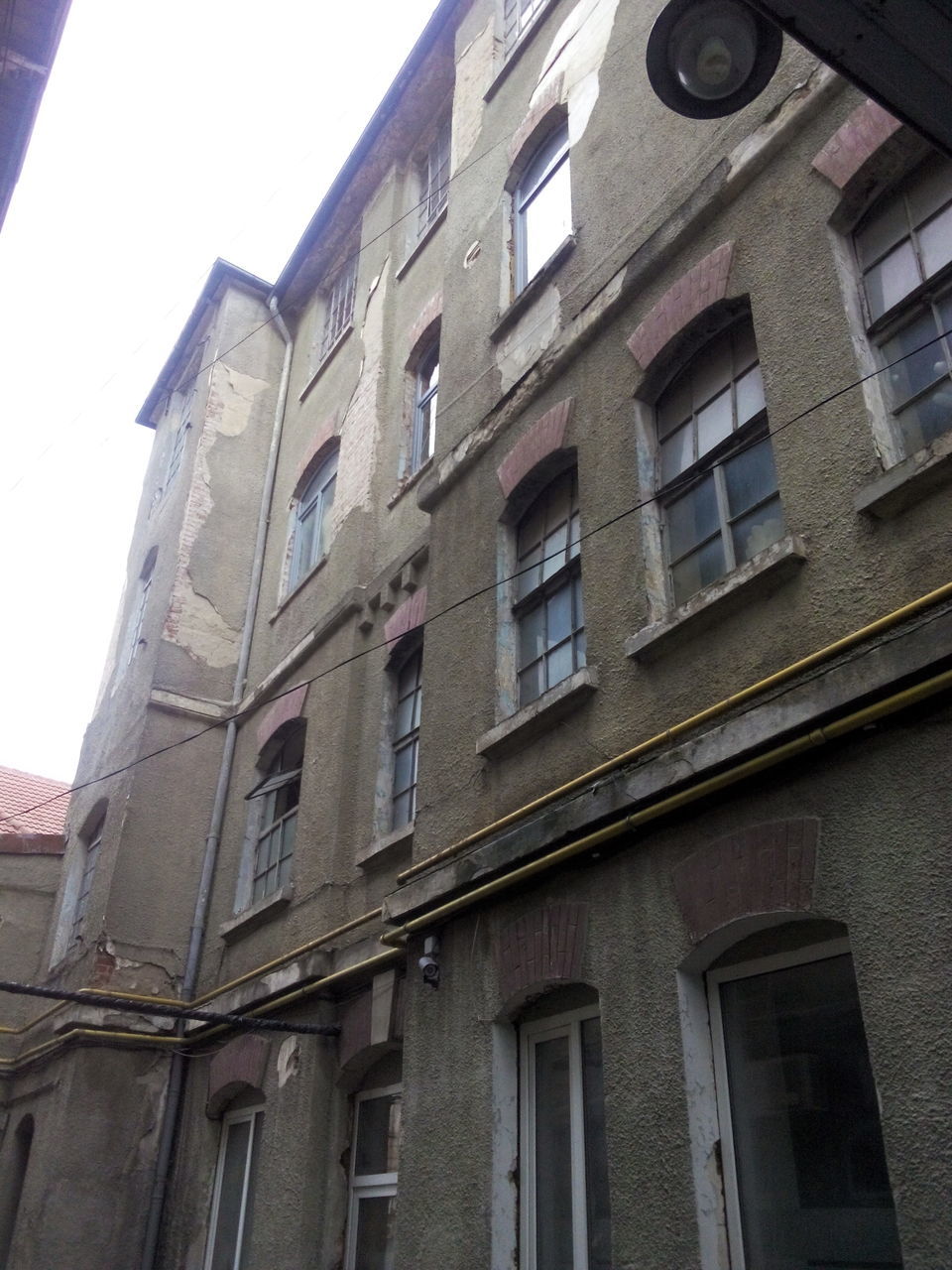 architecture, building exterior, built structure, low angle view, window, building, residential building, residential structure, city, day, sky, outdoors, brick wall, no people, clear sky, apartment, facade, balcony, house, glass - material