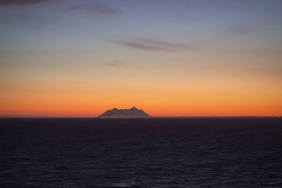 Scenic view of sea against romantic sky at sunset