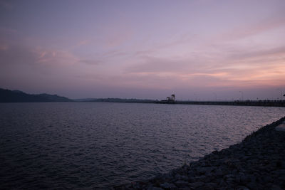 Scenic view of beach against sky during sunset