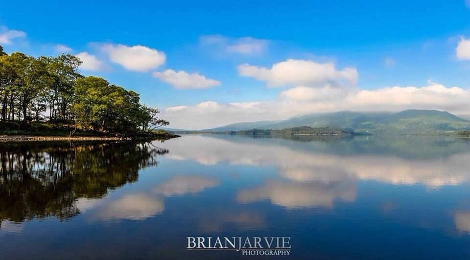 water, sky, lake, tranquil scene, mountain, tranquility, reflection, tree, scenics, cloud - sky, river, beauty in nature, nature, cloud, blue, waterfront, mountain range, day, outdoors, idyllic