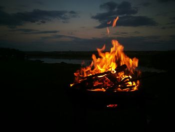 Close-up of bonfire against sky during sunset