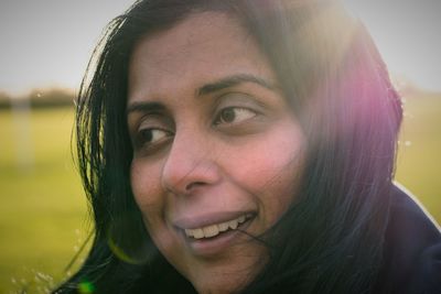 Close-up of thoughtful woman on field