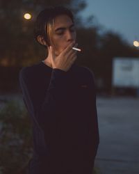 Side view of man smoking cigarette