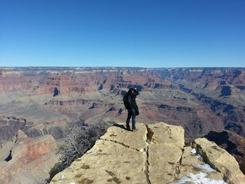 Full length of woman standing on rock formation
