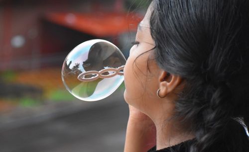 Portrait of woman holding bubbles