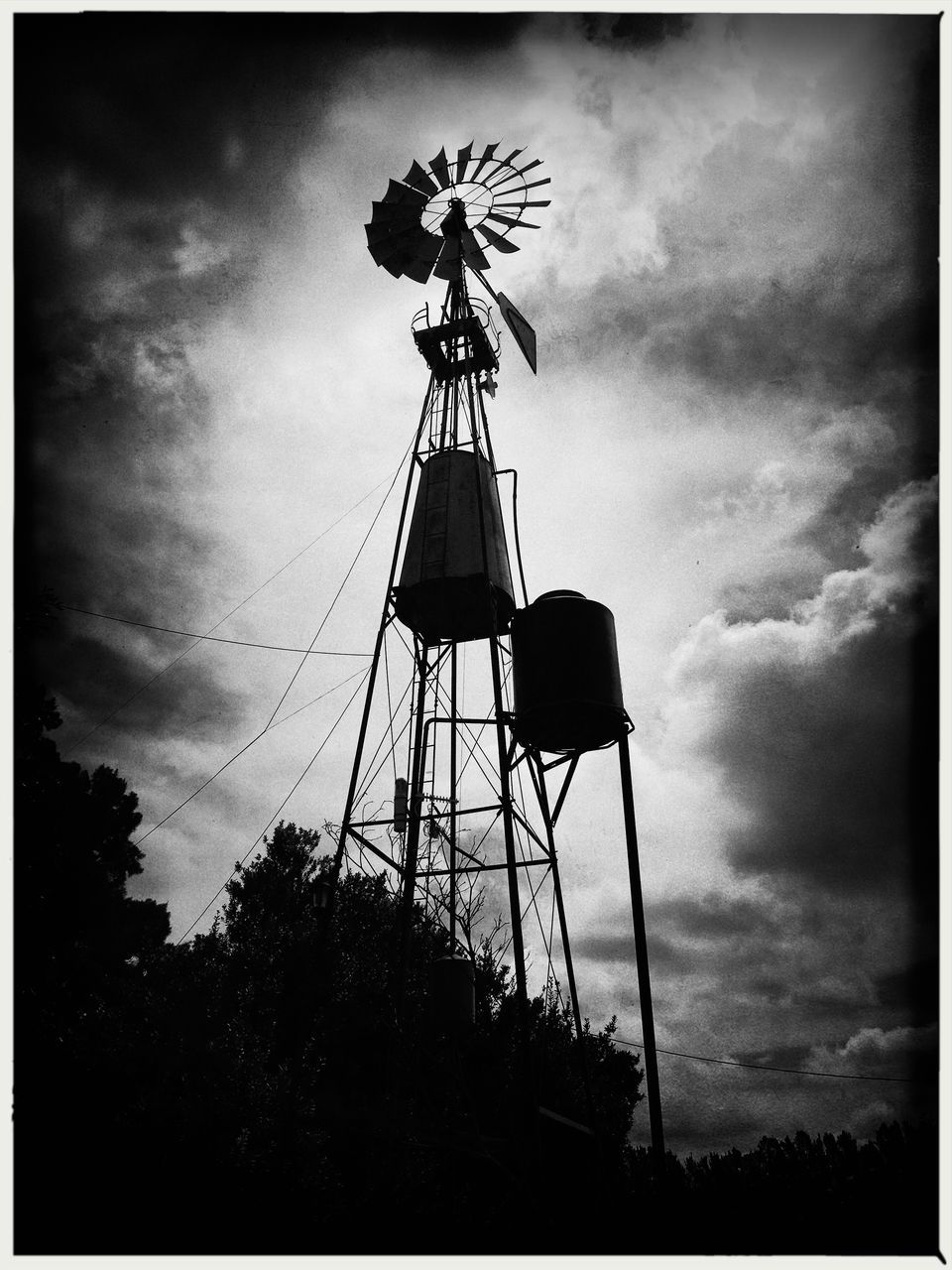 LOW ANGLE VIEW OF SILHOUETTE CRANE AGAINST SKY