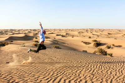 Full length of man in desert against clear sky