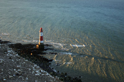 High angle view of lighthouse by sea