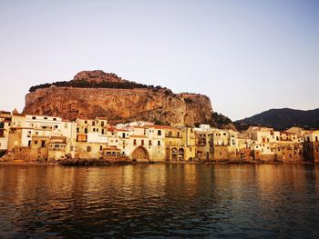 Town by sea against clear sky