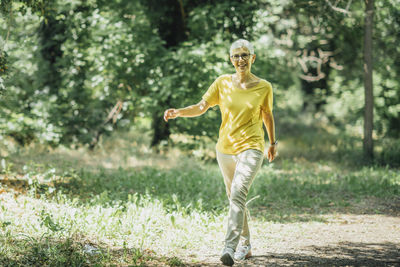 Portrait of a woman standing on field