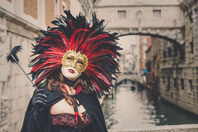 Midsection of woman with umbrella during festival