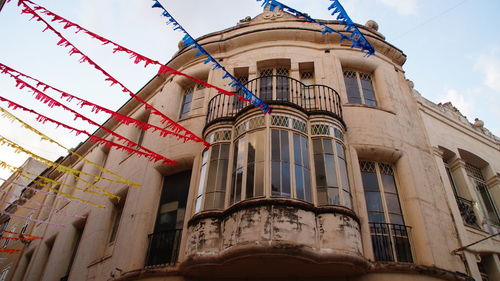 Low angle view of decorated building against sky