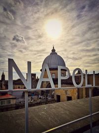 Building against sky during sunset in city