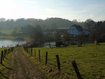 Scenic view of farm against sky