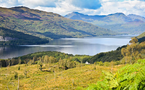 Scenic view of lake and mountains against sky