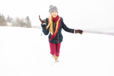 Portrait of smiling young woman in snow