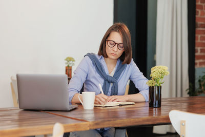Portrait of young businesswoman working at desk in office