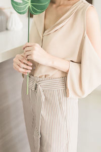 Close-up of young woman standing on hand