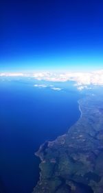 Aerial view of sea against blue sky