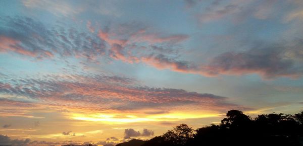 Low angle view of cloudy sky at sunset