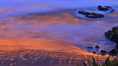 Aerial view of sea against sky during sunset