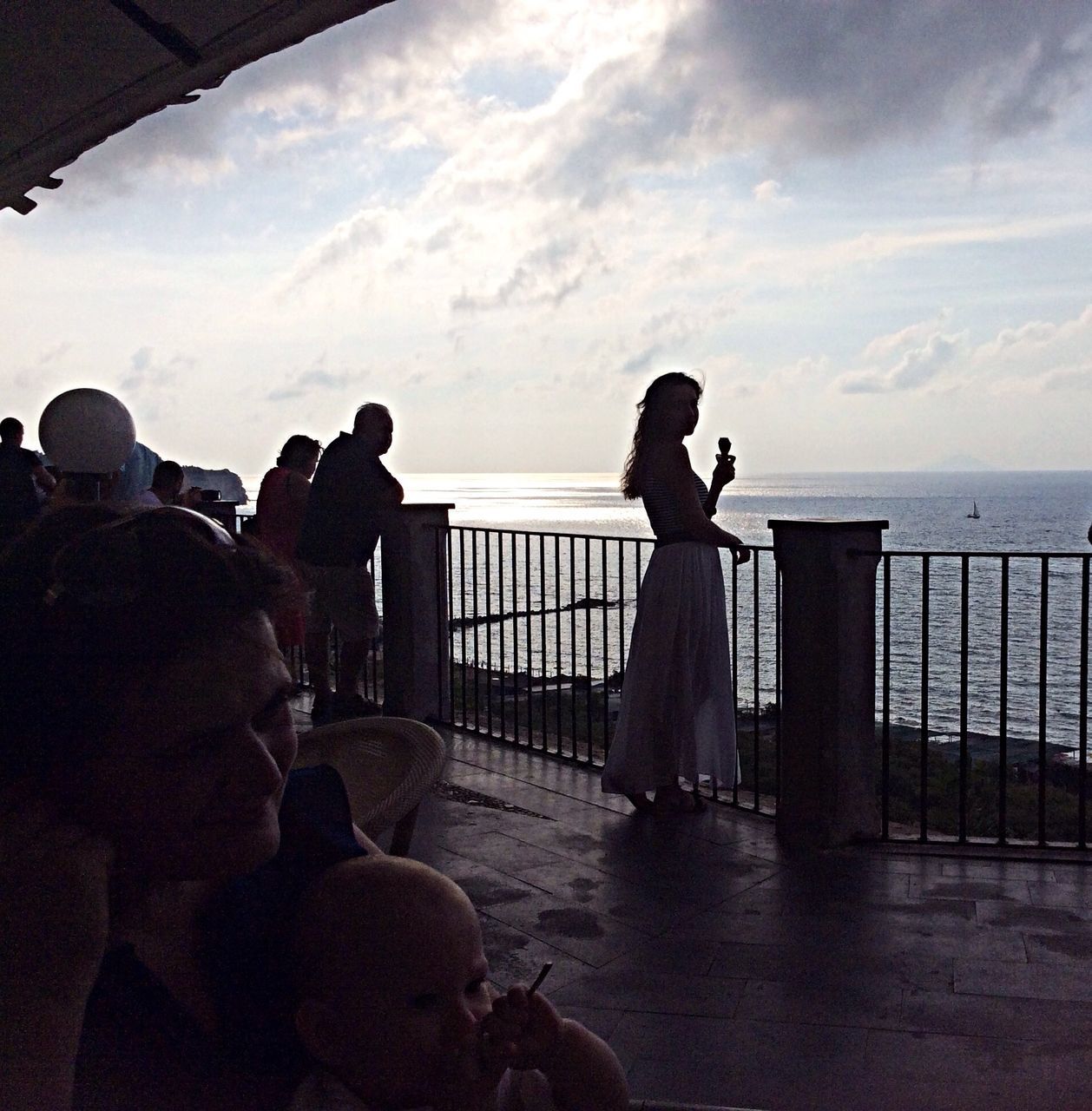 sea, sky, water, lifestyles, men, horizon over water, silhouette, leisure activity, cloud - sky, person, togetherness, standing, rear view, railing, cloud, bonding, looking at view, nature