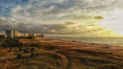 Scenic view of beach against sky during sunset