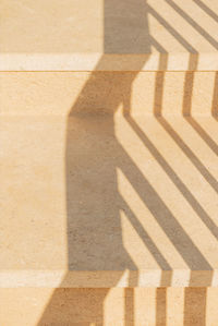 Geometric shadows on stone yellow steps. abstract sunny background