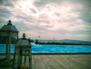 View of swimming pool by building against sky