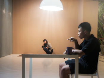 Young couple sitting on table