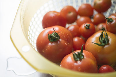 Close-up of wet cherry tomatoes in basket