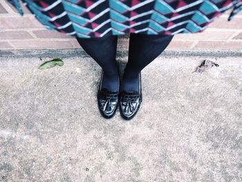 Low section of woman standing on tiled floor