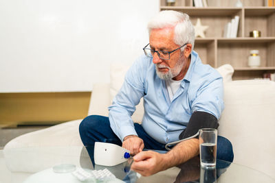 Portrait of senior man working at home