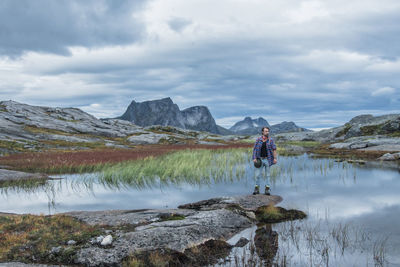 Man standing on mountain against sky