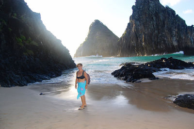 Full length of woman on beach against sky