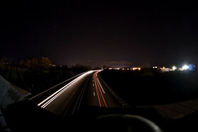 Illuminated city against sky at night