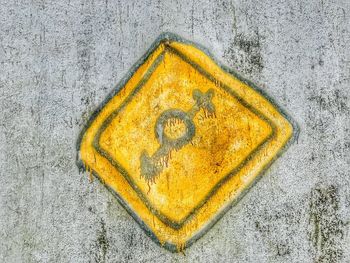 Close-up of yellow text on wall